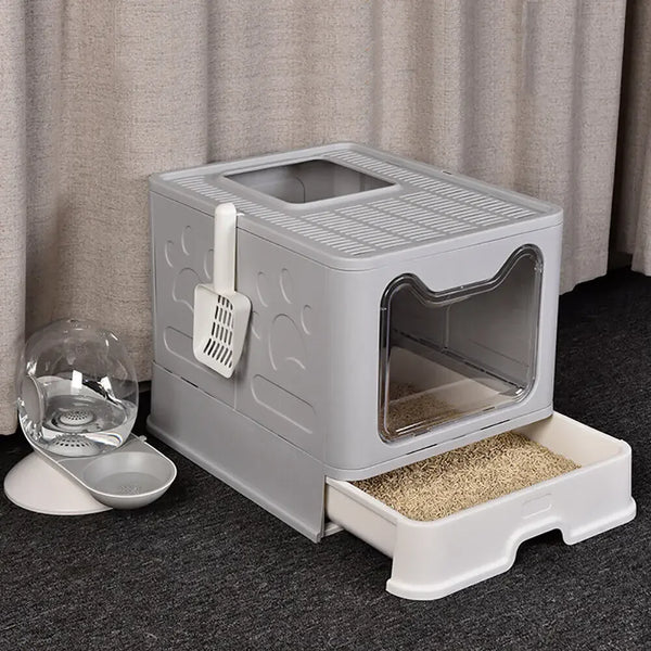 A gray foldable cat litter box with a front entry and top exit is shown on a dark surface.
