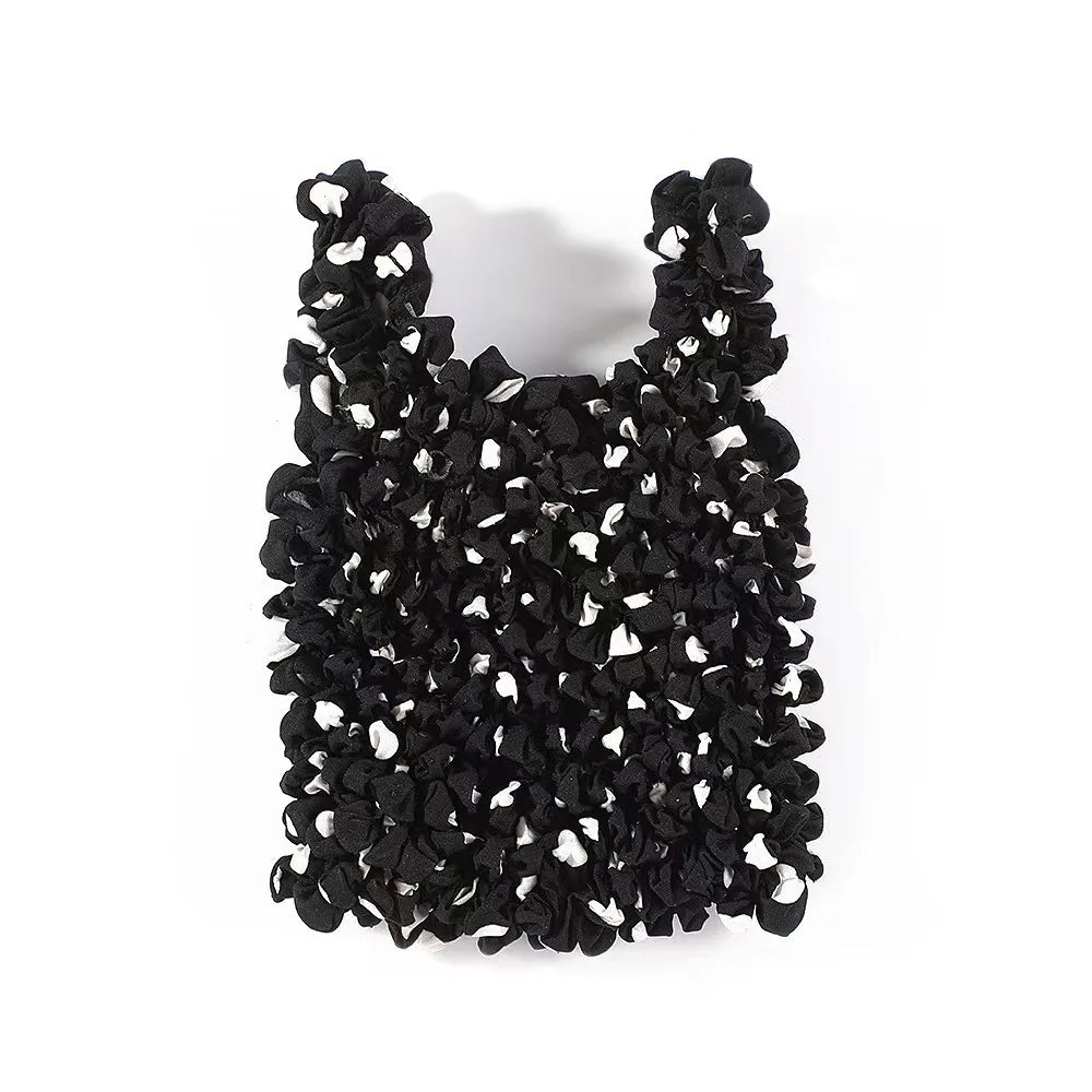 A black reusable foldable bubble shopping bag made of crinkled plastic.