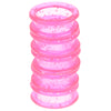 A stack of pink silica gel hair scissors, showing multiple rings with small glitter particles.
