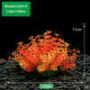 A dense cluster of bright orange and yellow artificial aquarium plants growing in dark gravel.