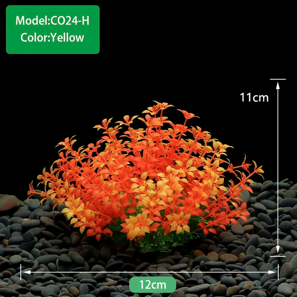 A dense cluster of bright orange and yellow artificial aquarium plants growing in dark gravel.