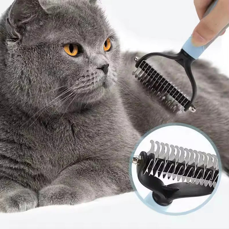 A gray cat is being groomed with a stainless steel pet hair remover comb.