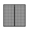 A black foldable metal mesh pet gate and barrier with a hinge visible on the center seam.