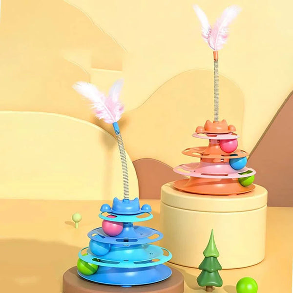 A colorful interactive cat turntable toy with a feather wand and rolling ball displayed on a light wooden surface.