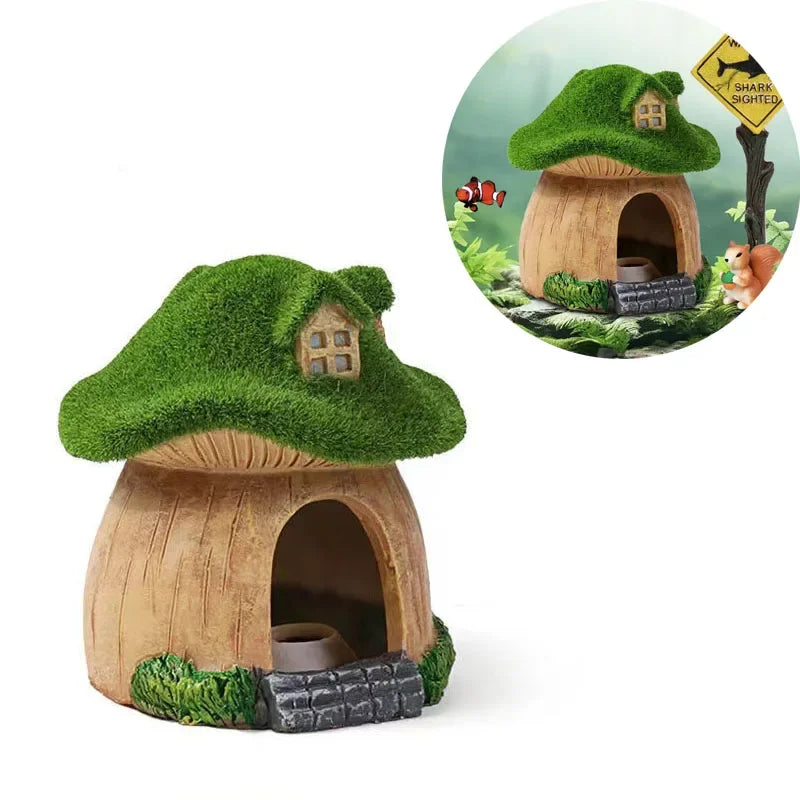 A miniature resin aquarium house decor with a green thatched roof and wooden structure, featuring an entrance for small fish.