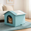 A light blue foldable waterproof insulated cat house with an arched entrance featuring a cat's face.