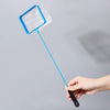 A hand holds a blue mesh aquarium fish net with a long handle against a light gray background.