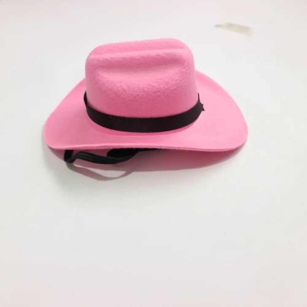 A bright pink felt cowboy hat with a black band, shown from above.