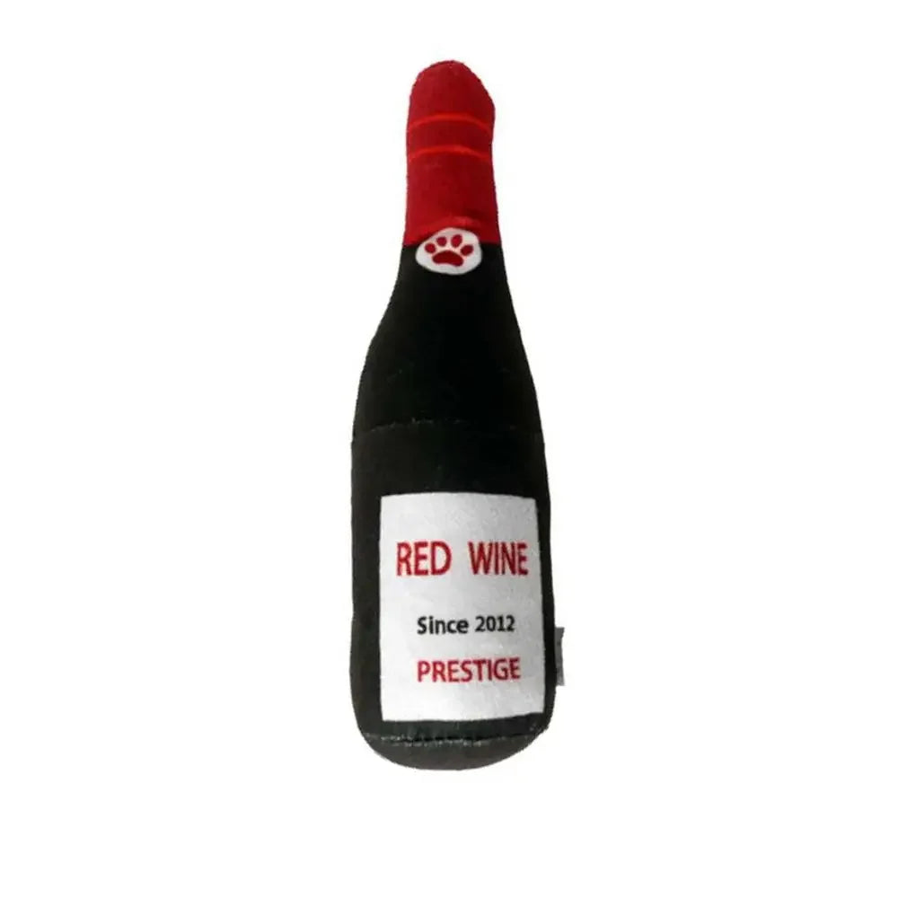 A black bottle-shaped squeaky plush dog toy with a red tip and white paw print detail.