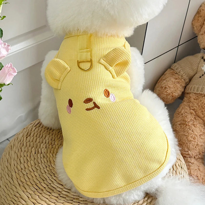 A yellow waffle knit pet vest for a dog or cat is shown against a white background.