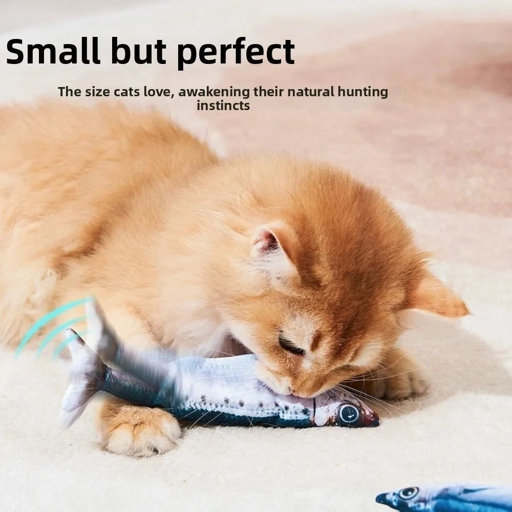 A small orange kitten is interacting with a blue fish toy on a light surface.