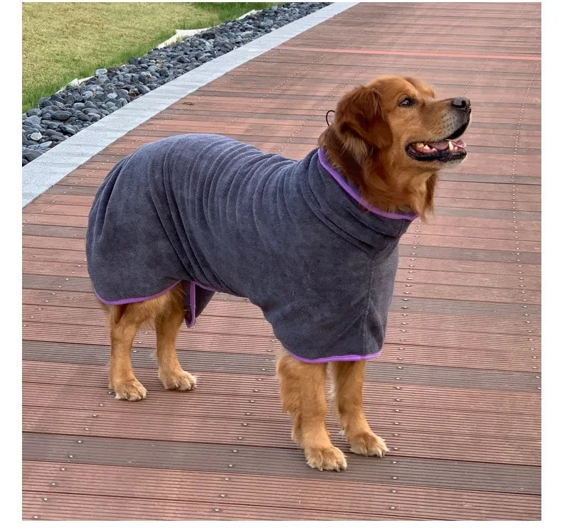 A brown dog wearing a gray quick-dry microfiber robe on a wooden deck.
