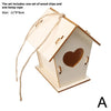 A wooden bird house kit with a slanted roof and a heart cutout, tied with hemp rope.