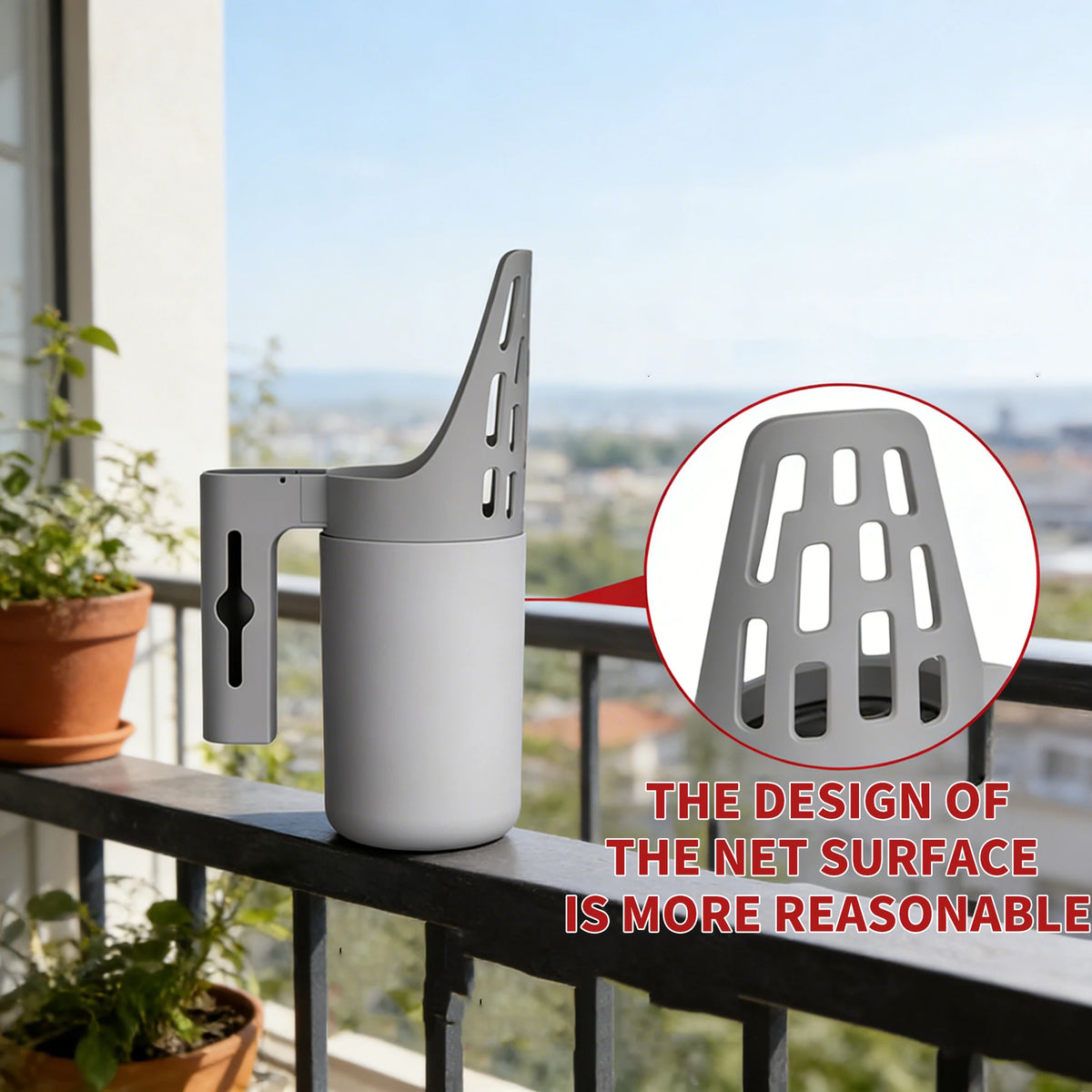 A white cat litter scoop and sifter is displayed on a balcony railing with a blurred city view in the background.