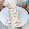 A light yellow floral summer dress for dogs or cats with ruffles and a silver clasp.