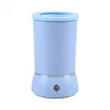 A light blue automatic pet paw cleaner cup with a silver base and charging port.