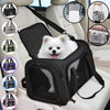 A black portable pet carrier bag with a white dog inside, shown in a car seat context.