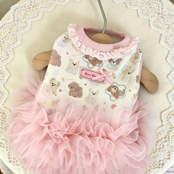A pink pet dog dress with a ruffled collar and a layered tulle skirt featuring small dog illustrations.