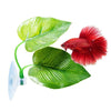 A red betta fish is resting on a green leaf hammock attached to a suction cup.