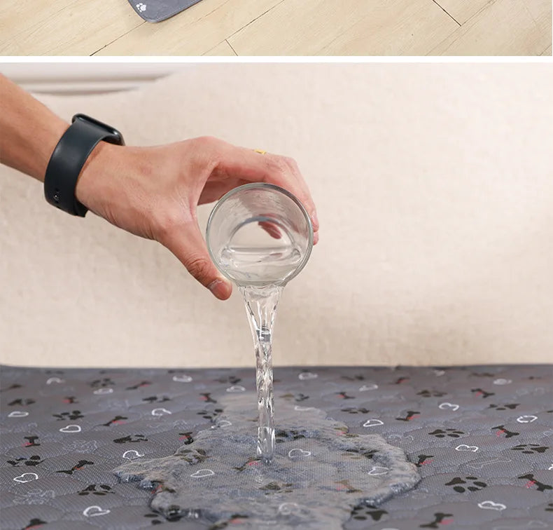 A hand pours water from a glass into a pet pee pad for washing.