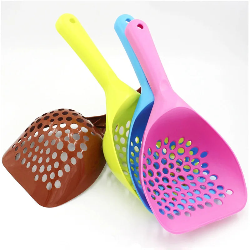 A set of three plastic cat litter scoops in yellow, blue, and pink with extra-long handles.