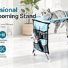 A gray cat is resting in a blue grooming hammock suspended from a professional pet grooming stand.