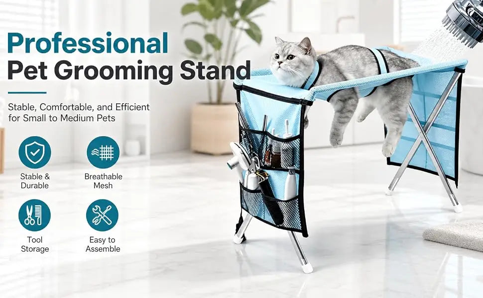 A gray cat is resting in a blue grooming hammock suspended from a professional pet grooming stand.