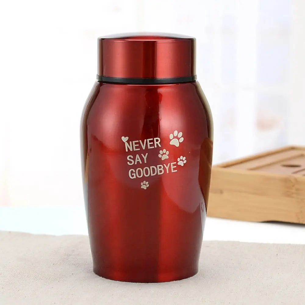 A reddish-brown stainless steel pet memorial storage box with a black lid and engraved text saying Never Say Goodbye.