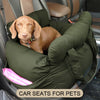 A light brown dog is resting inside a green pet car seat placed in a vehicle.