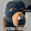 A close-up photo of a dog wearing a black knitted mask accessory.
