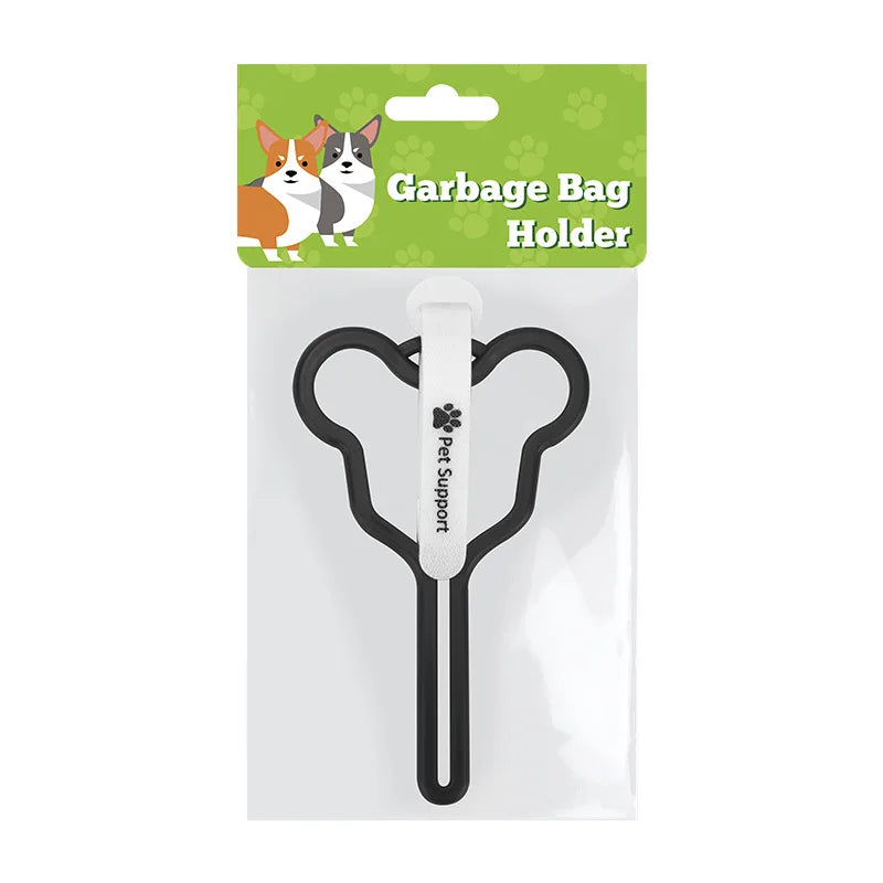 A clear plastic holder for a garbage bag, featuring a black leash clip and a white handle.