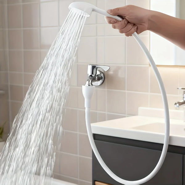 A hand is operating a white 360° flexible faucet sprayer with a spray head over a kitchen sink.