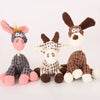 A set of plush squeaky donkey dog toys in various colors including gray, pink, and brown.