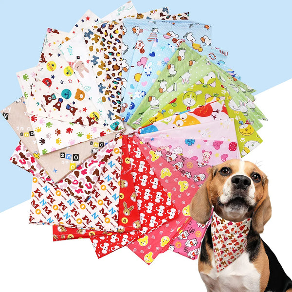 A pile of colorful cotton triangle bandanas for dogs and cats next to a dog.