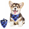 A cute puppy wearing a blue and black plaid bandana around its neck.