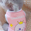 A pink sleeveless vest featuring a dinosaur design worn by a small pet.