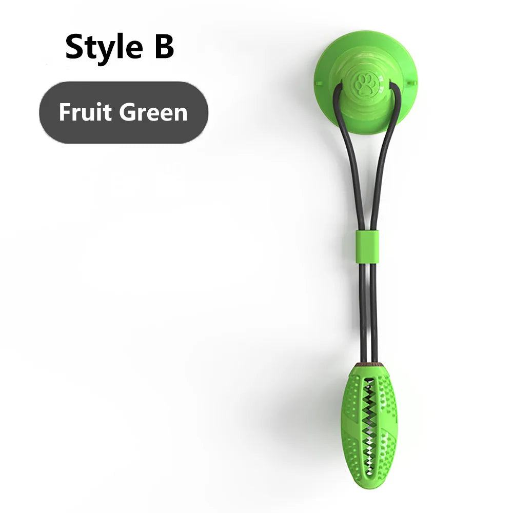 A bright fruit green interactive suction cup tug dog ball with a black cord and grip.