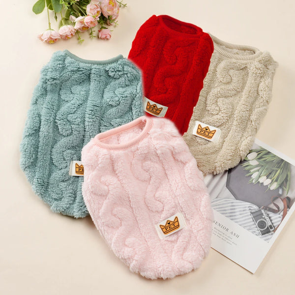 Three cozy fleece dog sweaters in red, teal, and beige are displayed on a light background.