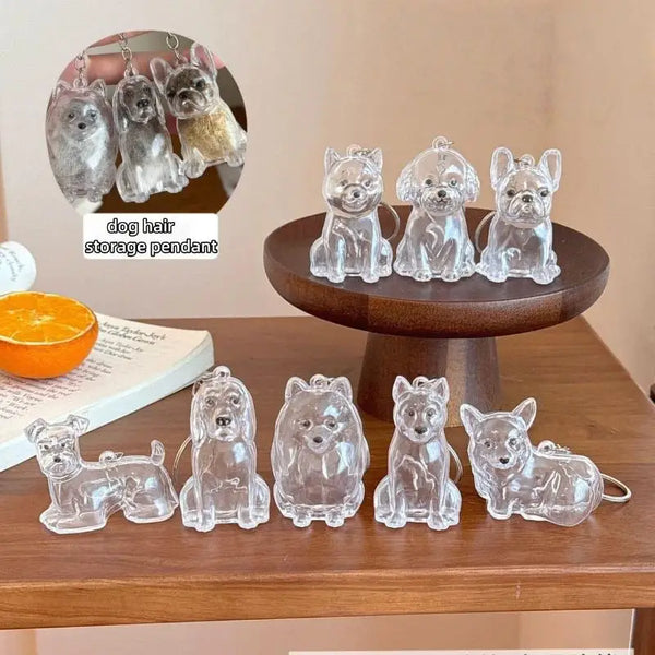A collection of clear silicone dog hair storage pendants and keychains displayed on a wooden table.