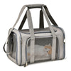 A gray travel pet carrier bag with padded straps, featuring a mesh window showing a small orange kitten inside.