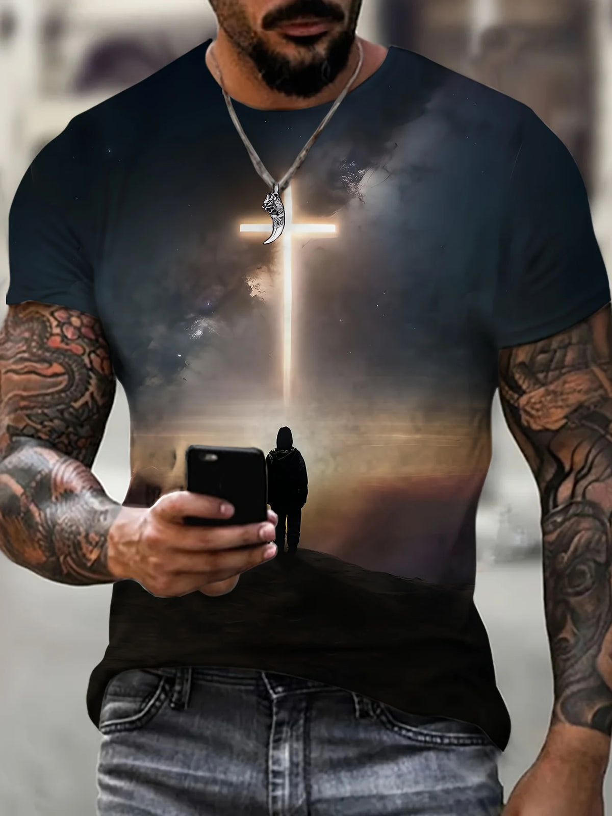 A man wearing a dark t-shirt with a graphic of a glowing cross and silhouette of Jesus on it.