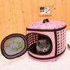 A pink breathable pet carrier backpack with a mesh window for a cat is displayed on a light surface.