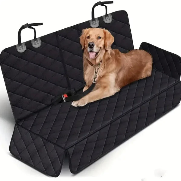 A brown dog is resting in a black quilted waterproof car seat cover with safety straps.