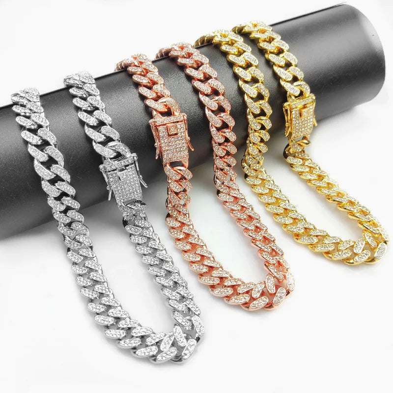 Cinq colliers de chokers en diamant, dorés et argentés, disposés sur une surface sombre.