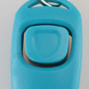 A light blue dog training clicker and whistle attached to a keyring.