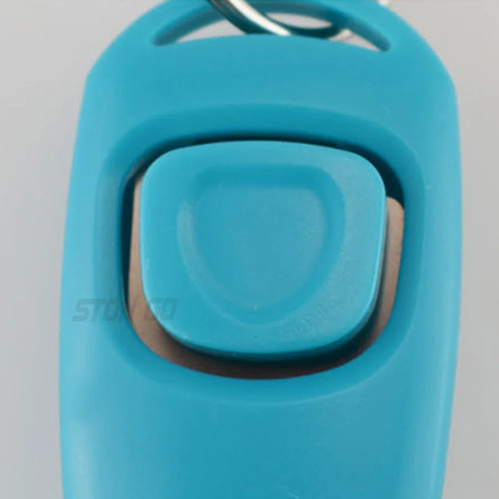 A light blue dog training clicker and whistle attached to a keyring.