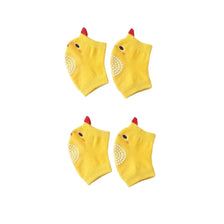 Two yellow knitted dog knee pads with embroidered faces and red ears.