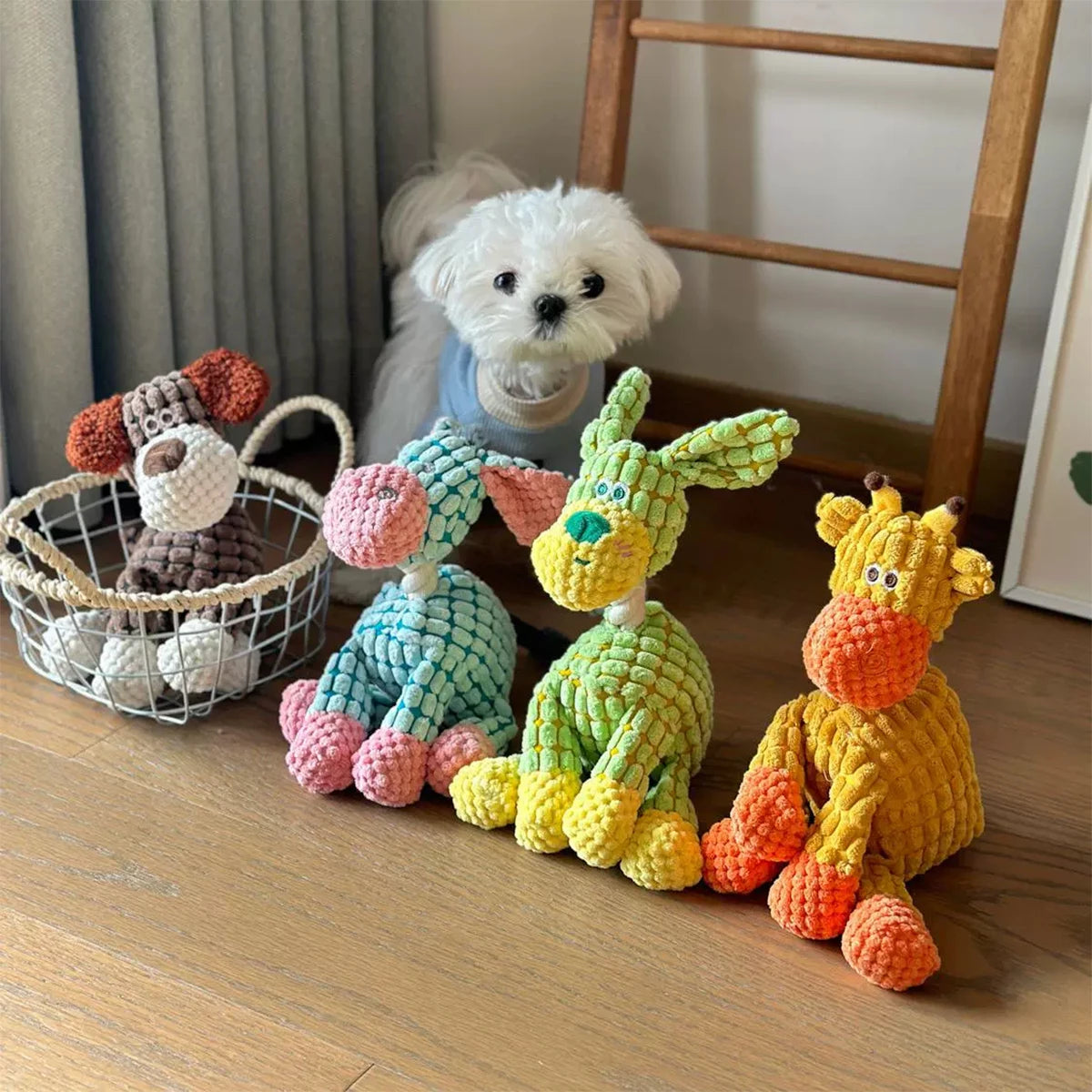 A collection of handmade plush donkey toys in various colors and textures displayed on a wooden surface.