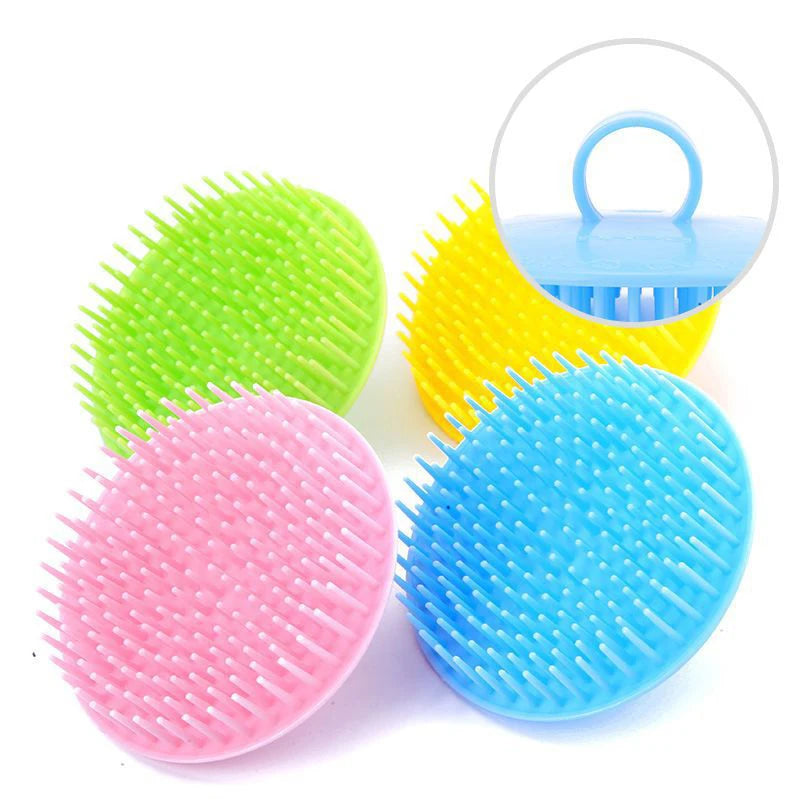 A collection of silicone hair and scalp massage brushes in green, yellow, pink, and blue.