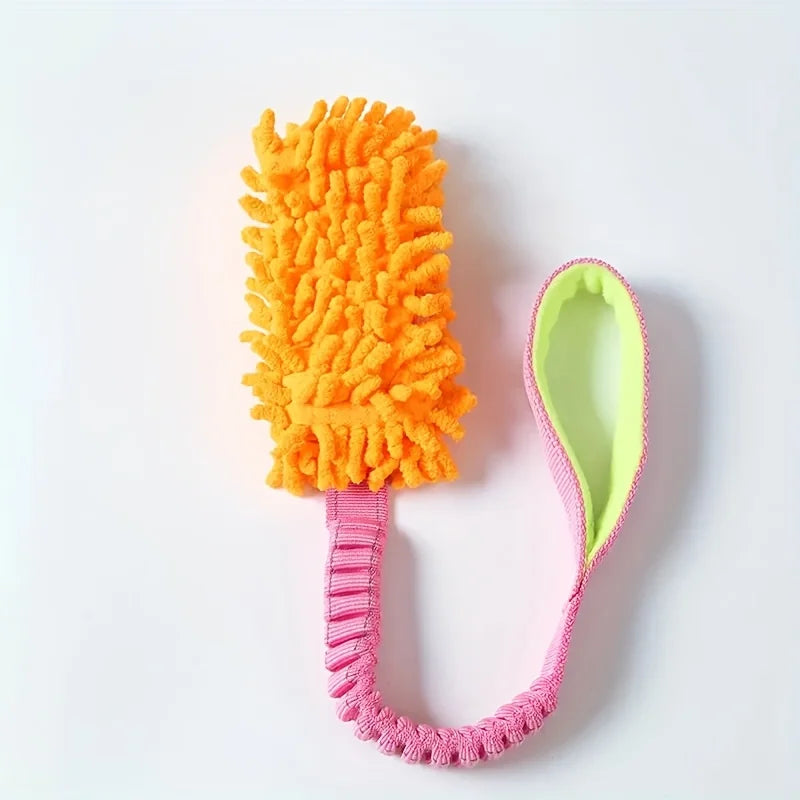 An orange plush pull rope toy with a pink handle and green grip is shown on a white background.